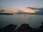 A Sailboat, a Ferry and a Sunset